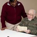 Clay County 4-H agent Fran Brock and volunteer leader Norman Armstrong look over one of his old scripts from a radio program he did as a member and leader to promote 4-H involvement. (Photo by MSU Ag Communications/Scott Corey)