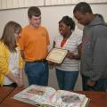 Looking over their winning application for national recognition are Mississippi State University Collegiate 4-H'ers, from left, Savannah Duckworth of New Albany, Stuart Wright of Columbus, Brittany Reed of Greenwood and Shad Benn of Hattiesburg. (Photo by Scott Corey)  