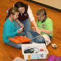 Kaitlyn Plance, left, and Jordan Jackson, right, work to build a robot with Amy Walsh, Amite County 4-H Agent. The youth are learning science, technology and engineering through the 4-H robotics program. (Photo by Mariah Smith)