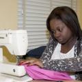 Constance Crockett of Hattiesburg puts the finishing touches on a dress she made in the Apparel Design I class at Mississippi State University's School of Human Sciences for the nonprofit charity Little Dresses for Africa.