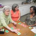 Georgia Murphy (center) observes a friendly card game between Florence Romero (left) and Bobbie Potts at the senior center on May 21, 2013, in Starkville, Miss. (Photo by MSU Ag Communications/Scott Corey)