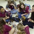 Melanie Barnett (far right), a second-year veterinary student at the Mississippi State University College of Veterinary Medicine, teaches young people enrolled in the college's Vet Camp how to perform a physical examination on a dog. (Photo by MSU College of Veterinary Medicine/Tom Thompson)