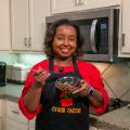 A woman holds a bowl of Teriyaki Meatballs.