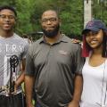 A 4-H volunteer leader with two 4-H members at a 4-H Shooting Sports event.