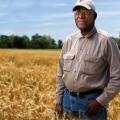 A man standing in a soybean field.