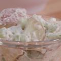 Potato salad in a small clear glass bowl