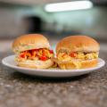 Two Microwave Denver Scramble Sliders sit on a plate on a kitchen countertop.