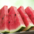 Close up of triangular watermelon slices on a plate.