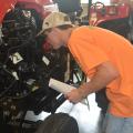 Rankin County 4-H member Robert Herrington takes a close look under the hood of a tractor as he identifies engine parts during a portion of the tractor competition on June 1, 2017. More than 700 4-H members took part in contests, workshops, tours and entertainment during their annual state meeting at Mississippi State University. (Photo by MSU Extension Service/Linda Breazeale)