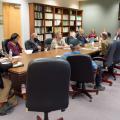 A group of people sitting around a table.