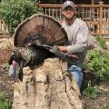 A hunter shows off a turkey he harvested.