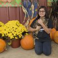 Katy Chen of Louisville, Mississippi, holds the unofficial mascot of May’s Corn Maze in Stewart, Mississippi, in front of the agritourism farm’s pumpkin patch. The state enjoyed a strong pumpkin harvest for the second straight year. (Photo by MSU Extension Service/Kevin Hudson)