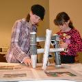 Lisa Cain, 11, and Mary Jane Cain, 10, use rolled-up newspaper to build a paper table at the Mississippi State University Mechanical Engineering Service Learning Showcase Nov. 20. 4-H members tested educational projects developed by MSU students in partnership with MSU’s Center for the Advancement of Service-Learning Excellence. (Photo by MSU Ag Communications/Bonnie Coblentz)