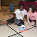 Samyra Harris, left, and Julia Schloemer focus intently on their Dash robot during the 4-H Cloverbud Robotic Camp at Mississippi State University on July 7, 2015. (Photo by MSU Ag Communications/Linda Breazeale)