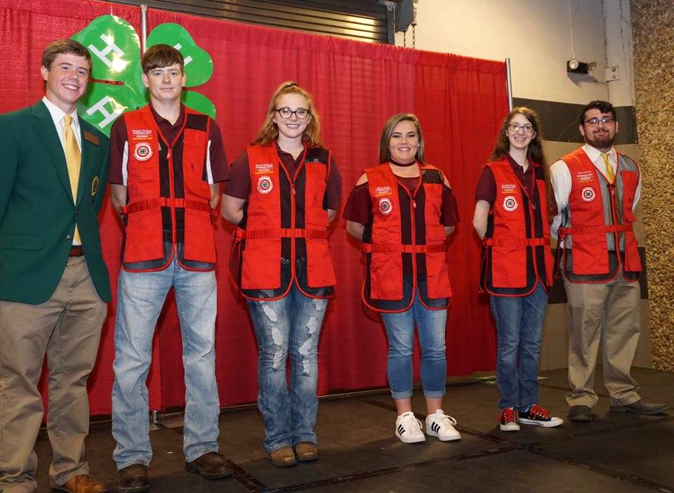 One male wearing green jacket. Five newest ambassadors after they were “vested” in orage.