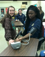 Students learning to take blood pressure readings.