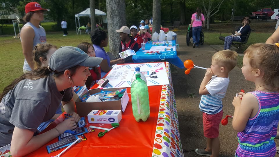 Dakota Edwards looks on as Senatobia Five Star City Fest participants learn about “lung capacity” at the Healthy Lung Kids station.